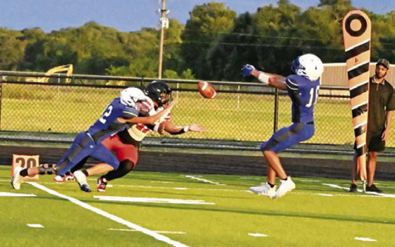 SNOOK’S CHRISTOPHER GOMEZ and Vince Nelson go for the ball against Hull-Daisetta in the Bluejays 42-14 opening win. Tribune photo by Denise Squier
