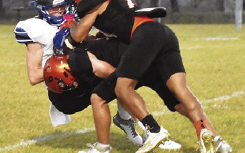 SOMERVILLE’S KASON Rohrbach and Steven Martinez tackle Snook’s Liam Zequeira. Tribune photo by Roy Sanders