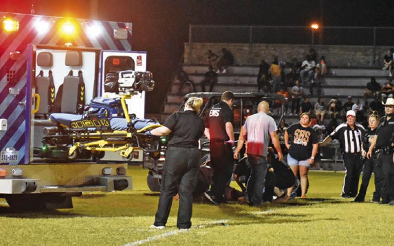 MEDICS RESPOND ON FRIDAY at the Somerville-Snook football game after a Snook player went down with an injury. Snook’s Michael Eaton was taken to an area hospital.