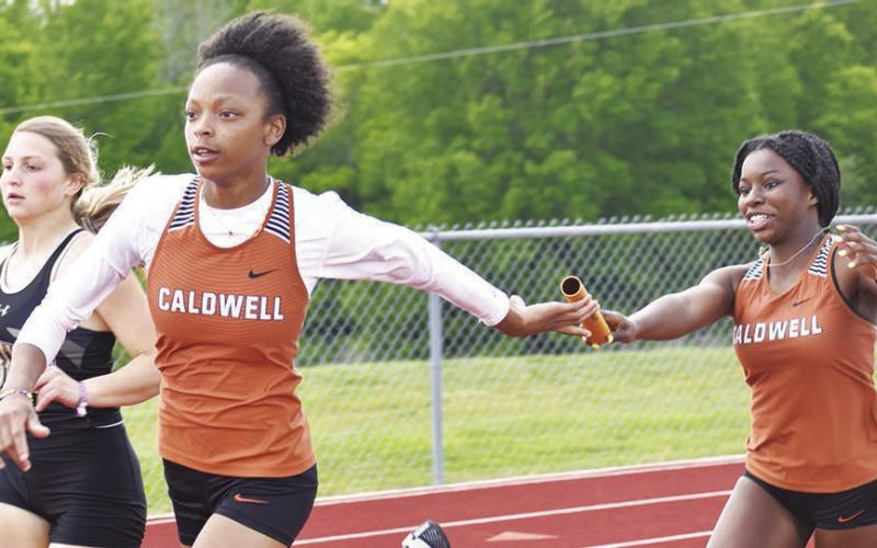 CALDWELL RUNNERS, Ja’Asia Mathis and Amoree Denson, pass the baton during a relay at last week’s Skrabanek Relays in Caldwell.