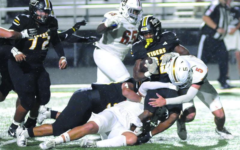 THE CALDWELL HORNETS defense led by John Fryrear tackle this Sealy ball carrier last Friday in Sealy. Caldwell lost 43-14. Tribune photo by Denise Squier