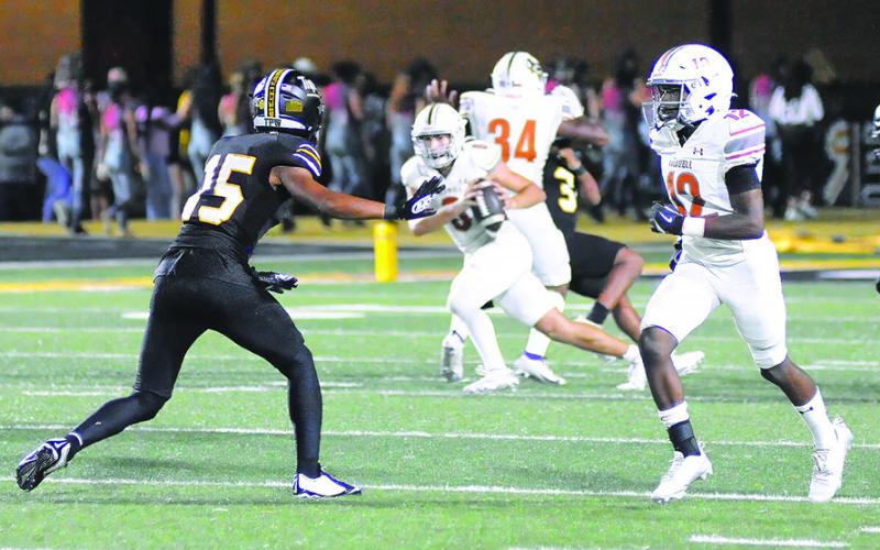 CALDWELL DEJUAN MATHIS moves in to block for quarterback Coy Becka, carrying the ball, in the Sealy game. Tribune photo by Denise Squier