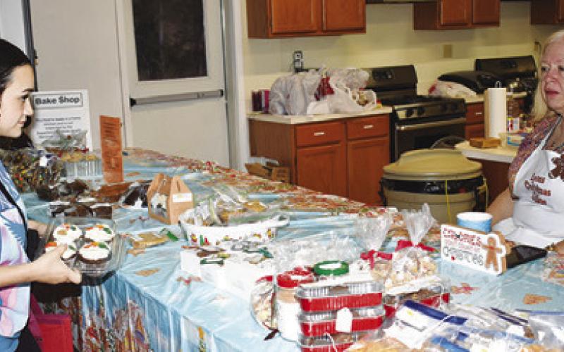 A customer shops at the bake shop portion of the Lyons Extension Club’s Christmas Cottage. Tribune photo by Roy Sanders