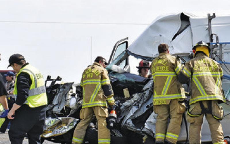 VOLUNTEER FIREFIGHTERS RESPOND to the scene of this accident on Monday on State Highway 21 West near County Road 110.