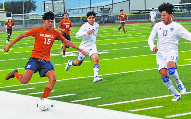 A CALDWELL PLAYER PREPARES TO PASS THE BALL DURING the Caldwell-Jarrell game last Friday night.