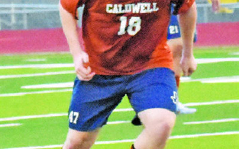 BARRET YATES DRIBBLES the ball up field during the Caldwell-Jarrell soccer game last Friday night.