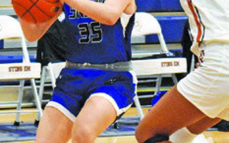 MACKENZIE GROCE looks to pass during the Snook-Caldwell game last Friday night in Hornet Gym.