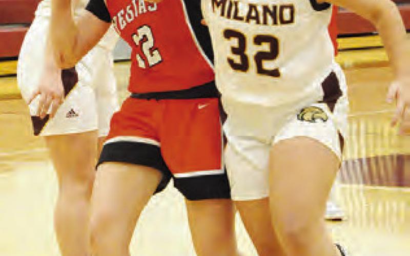 KYLIE NEUENDROFF tries to shoot the ball while Milano’s Elizabeth Pedroza defends. -- Tribune photo by Denise Squier