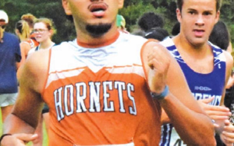 JUAN LAZO RACES across the finish line of the boys’ varsity race at the District 19-3A Cross Country Meet last week in Caldwell.