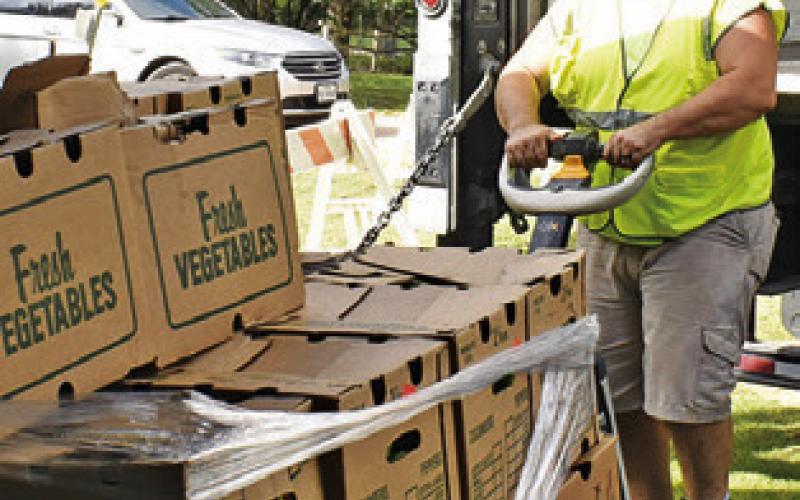 DAVID PALICKA OF In God’s Hands Ministry helps unload this food on Saturday morning at the food pantry in Cade Lake.