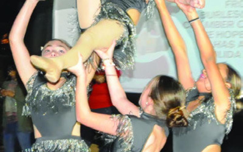 DANCERS FROM KICE’S Elite Dance Center lift the crowd’s spirits at last Friday night’s “Christmas on the Square.” Tribune photo by Denise Squier