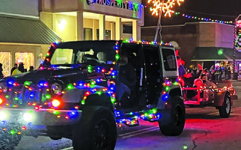 CARS AND OTHER VEHICLES WERE covered in Christmas lights in the lighted Christmas parade during “Christmas on the Square.” Tribune photo by Denise Squier