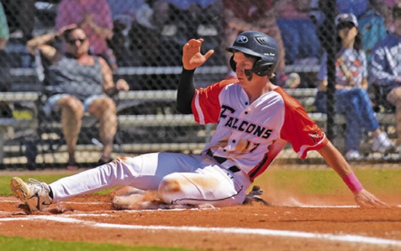CALDWELL’S DANIEL BARDIN slides into home during the Northside Falcons-Springfield Chargers baseball game at the Homeschool World Series tournament in Auburndale, Florida.