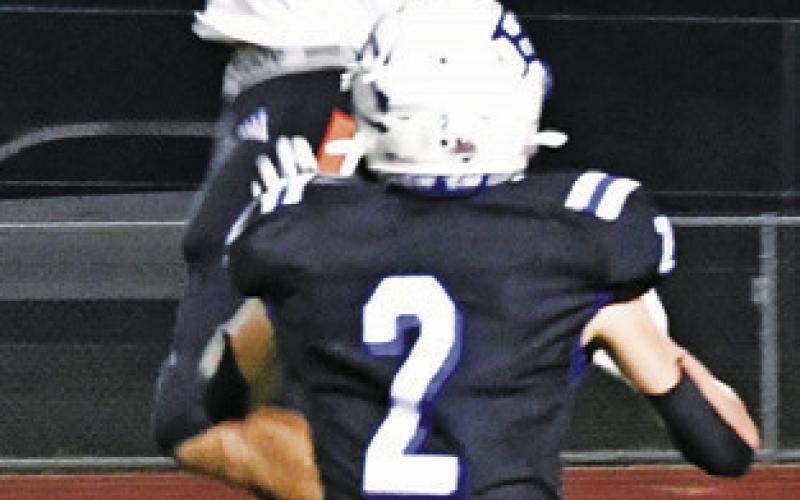 GARDNER SHIVERS leaps this catch against Falls City. -- Photo by Marian Laskowski