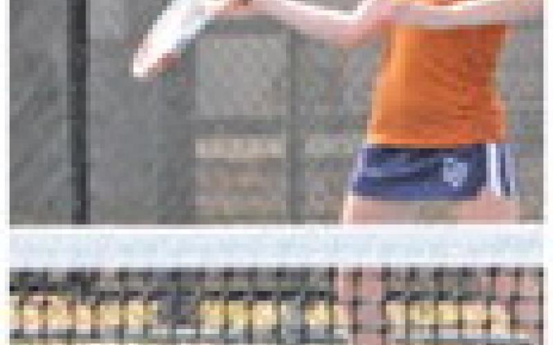 ADELINE HICKS returns serve during her girls doubles match against a team from Cameron Yoe. -- Tribune photo by Denise Squier