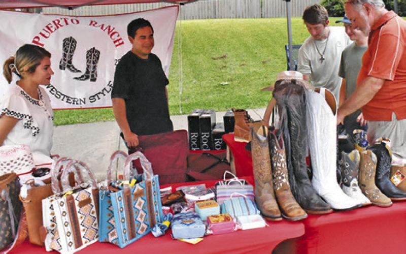 BOOTS AND PURSES were among the items on sale from street vendors on Saturday, July 13, at the Main Street concert and street dance.