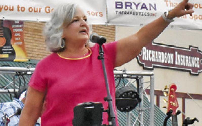 CALDWELL MAYOR Janice Easter addresses the crowd at the Saturday, July 13, concert and street dance in downtown Caldwell.