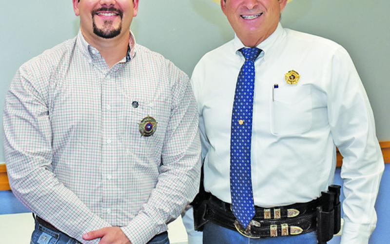 BERN COLLUM III is joined by Sheriff Bill Rios after being sworn in on Monday.