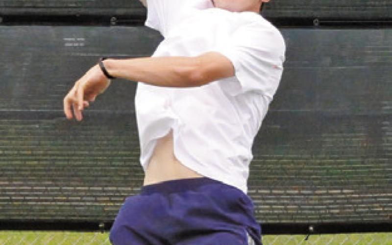CAYDEN ZBORIL leaps to smash the ball during a mixed doubles match at last week’s Class 4A Region 3 Tennis Tournament in Bryan.