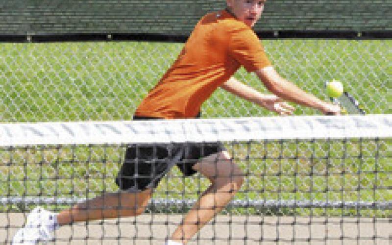 BILLY COCHRAN sets to backhand the ball during a boys doubles match at the Class 4A Region 3 Tennis Tournament at Rudder High School. -- Tribune photo by Denise Squier