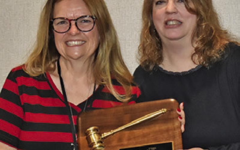OUTGOING TEXAS Gulf Coast Press Association President Regina Keilers is handed a plaque for her service to the organization by incoming president Denise Squier. Tribune photo by Roy Sanders