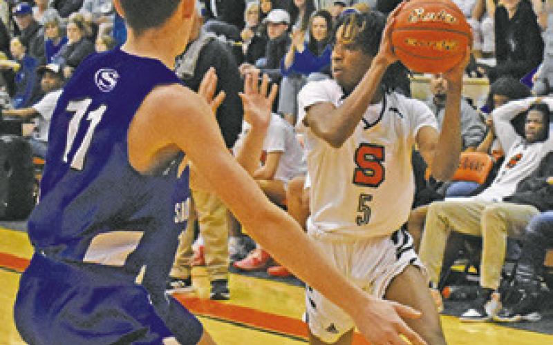 BRANDYN CARTER of Somerville prepares to pass as Josh Green of Snook defends.