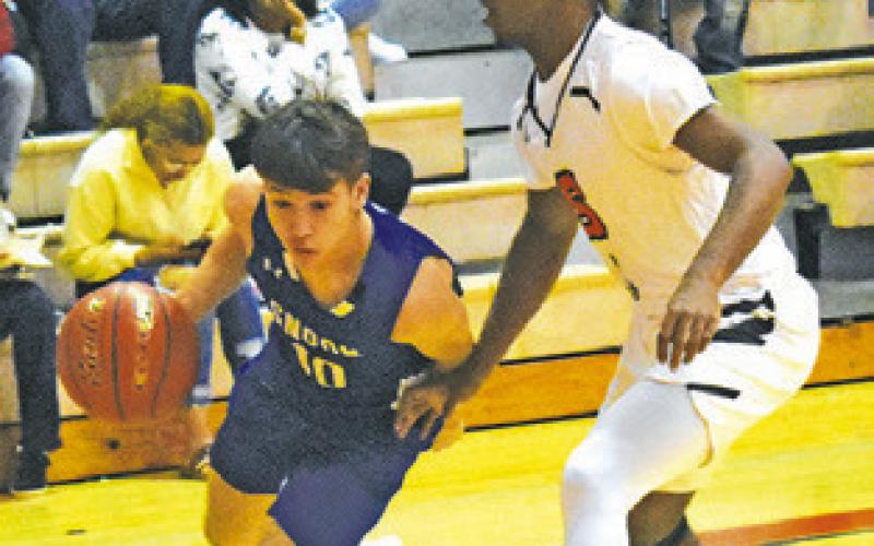 SNOOK’S LANCE LARA dribbles the ball past D.J. Bryant of Somerville.
