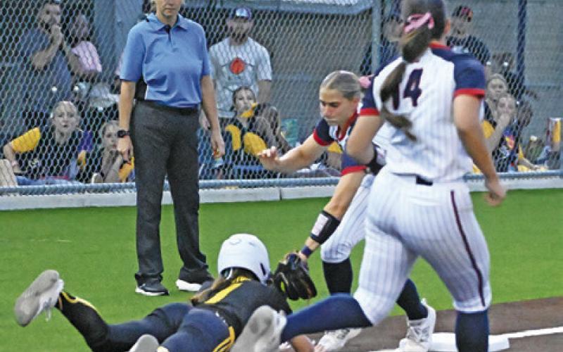 WIMBERLEY INFIELDERS picked off Liberty’s Marley Mouton trying to get back to third base during their state semifinal softball game. Tribune photo by Denise Squier