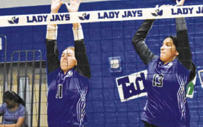 SNOOK’S MACKENZIE GROCE and Jadeyn Lara jump to attempt a block during the Lady Jays’ win over Buckholts last Friday 25-20, 25-19, 25-9. Snook also hosted Anderson-Shiro last Tuesday, falling to the Lady Owls 6-25, 14-25, 17-25. -- Tribune photo by Roy Sanders