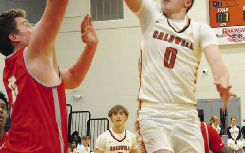 CADEN ZBORIL LEAPS high for this shot last Friday against Bellville. The Hornets lost their last home game 69-49. Tribune photo by Denise Squier