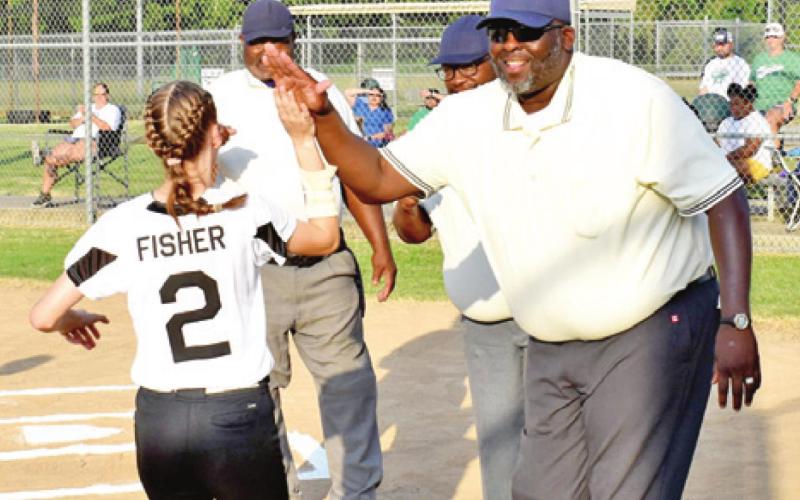 THE UMPIRES WELCOME the players from both teams onto the field prior to Monday’s Columbus-Hempstead softball game.
