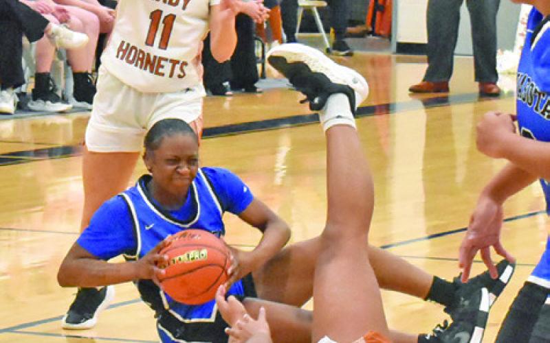 SEVERAL LADY HORNETS scramble for possession with a Navasota player during Caldwell’s 48-21 loss to Navasota last Friday night. Tribune photo by Roy Sanders