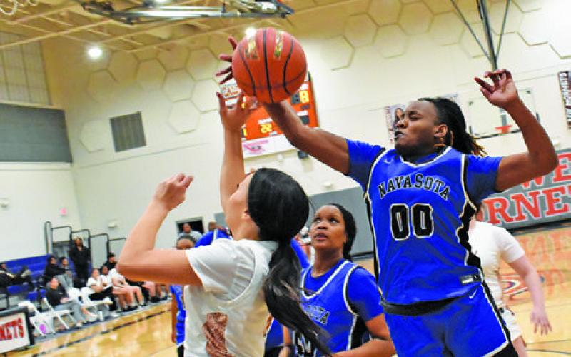 CALDWELL’S CHASSIDY ROGERS is fouled is fouled by a Navasota player while shooting during the Lady Hornets’ 48-21 home loss. Tribune photo by Roy Sanders