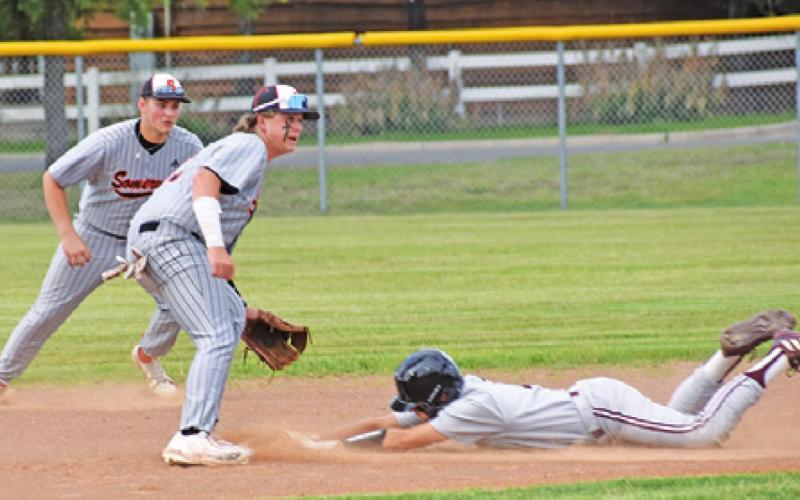 SOMERVILLE’S ROSS DUBOIS and Payton Sprouse wait for the ball as this Iola base runner slides into second base.