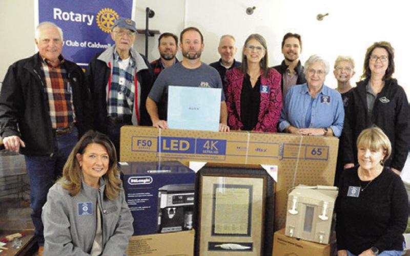 THE ROTARY CLUB OF Caldwell is gearing up for this Saturday’s annual “Casino Night” at the Burleson County Expo Center. Pictured are Rotary Club members with some of the prizes that event goers may win during the event’s prize drawings. Tribune photo by Denise Squier
