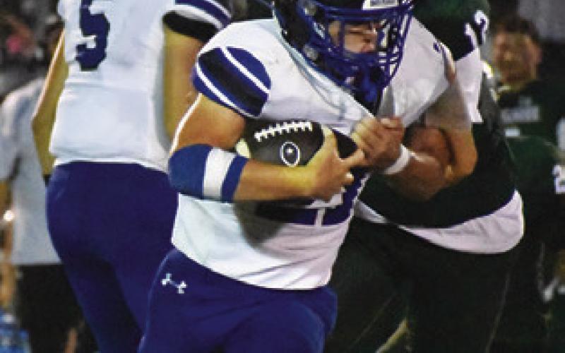 MICHAEL EATON carries the ball for Snook last Friday against Normangee. Tribune photo by Roy Sanders