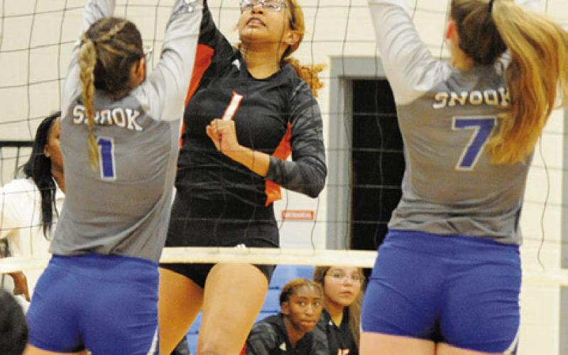 SOMERVILLE’S ALAZIA VELA’S hit is deflected off the top of the net for a kill during last Friday’s match against Snook.