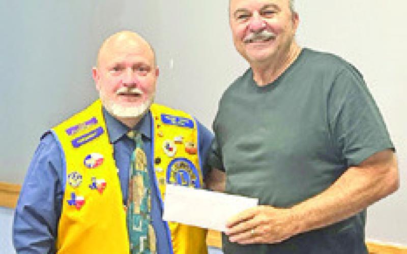 KEN WILTZ, President of the CBC Lions Club, presents a check for $2,500 to Mike Patranella, representing the Caldwell Boys and Girls Club. Photo courtesy of the Lions Club