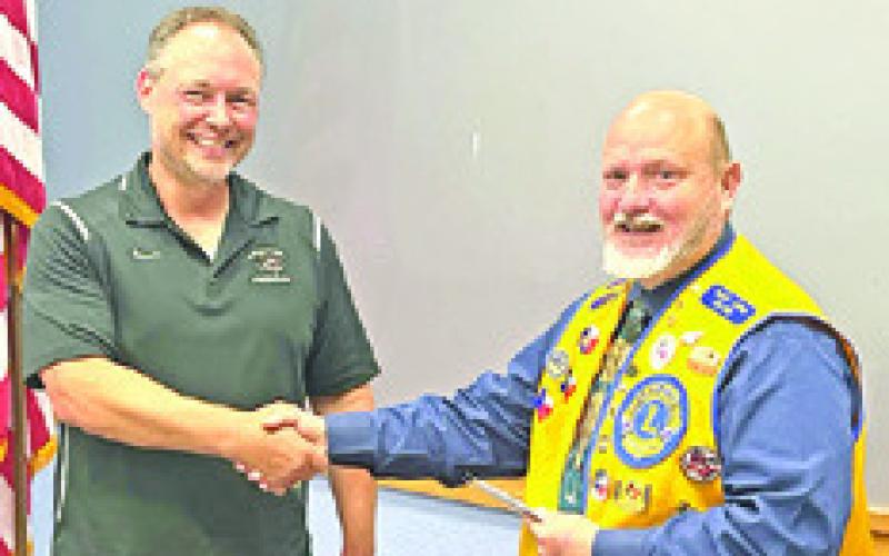 KEN WILTZ, President of the CBC Lions Club, presents checks for $1,000 to the Caldwell Elementary and Intermediate schools. Accepting the checks is Elementary School Principal Andrew Gandrud. Not pictured is Nicki Drgac, Intermediate School Principal. Photo courtesy of the Lions Club