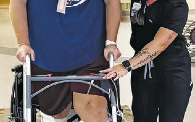 CALDWELL’S WES KAUDER goes through physical therapy to learn to walk again after surviving a hog attack in July.