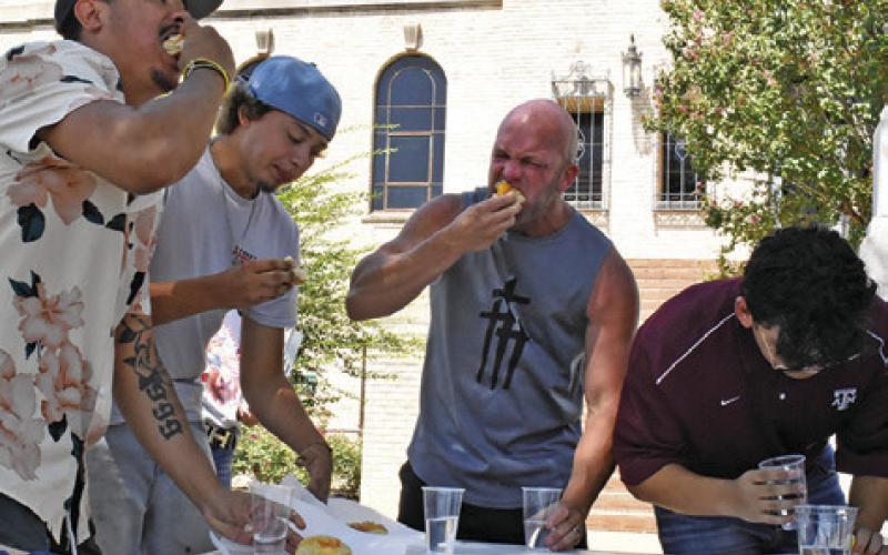 THESE MEN KEEP on eating as fast as they can in the contest.