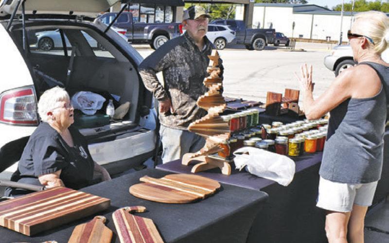 PAT AND BILL Baker talk to a customer on Saturday morning at the Farmers Market in downtown Caldwell.