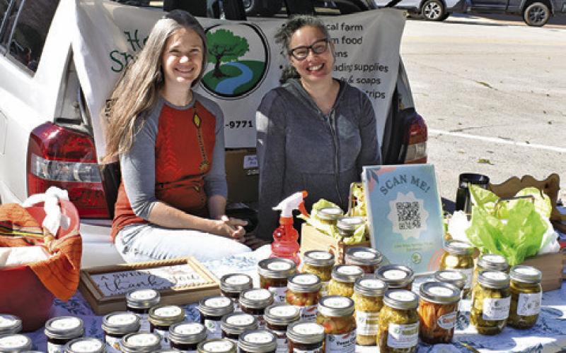ELIZABETH HANSARD and Misty Dean of Hopes Springs Farm display their items on Saturday at the Farmers Market in Caldwell.