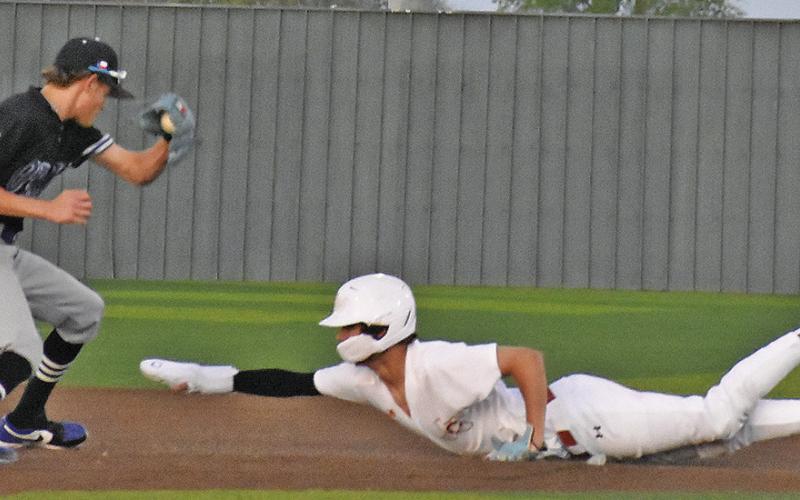 CALDWELL’S CHASE FAUST SLIDES into second base against Anderson Shiro. Tribune photo by Roy Sanders