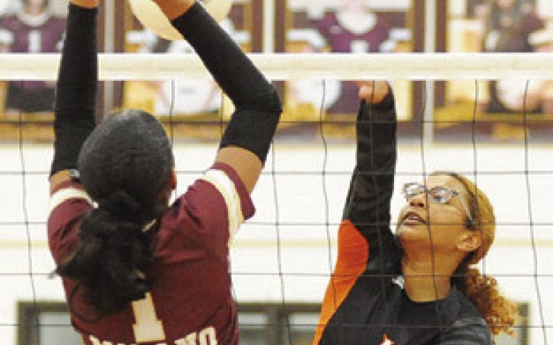 ALAZIA VELA attempts to hit the ball past a Lady Eagle blocker during the Somerville-Milano match last Friday night.
