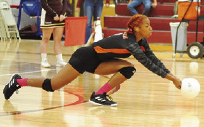 RA’MAYA CARTER dives to return serve during the Somerville-Milano match last Friday night. -- Tribune photo by Denise Squier