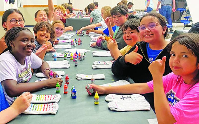 SNOOK FOURTH AND fifth-grade students created original designed non-slip socks with puff paints to donate to residents at the Burleson St. Joseph Manor in Caldwell. Snook partnered with members of the Texas A&amp;amp;M University Collegiate Farm Bureau for this project.