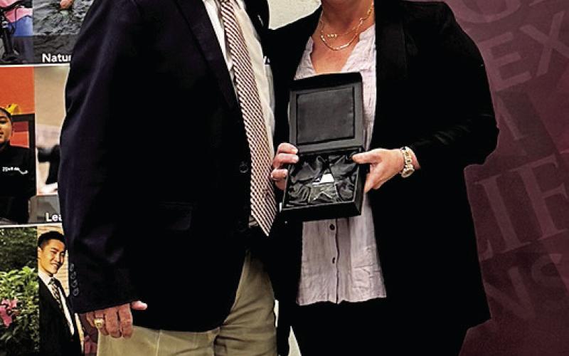 BURLESON COUNTY EXTENSION agent Holly Narro is pictured receiving her District 9 Rising Star award with district extension administrator Eric Zimmerman. Photo courtesy of Holly Narro