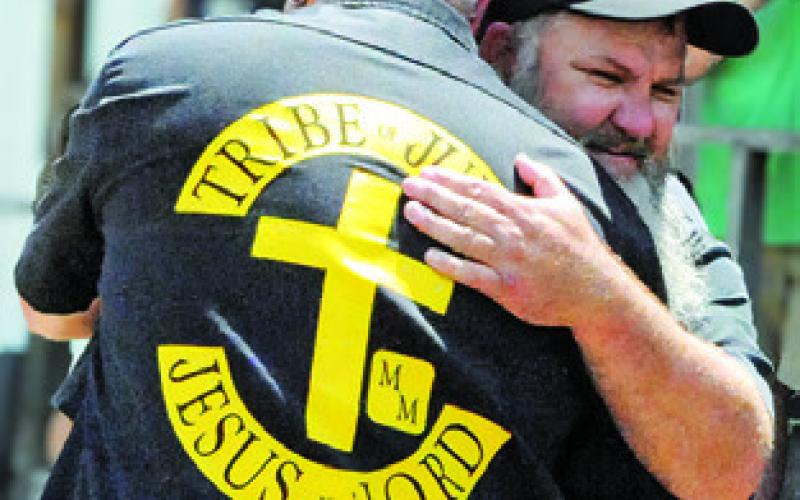 TIM OWENS HUGS those who came out to support him at last Saturday’s “Blessing of the Bikes,” before he participates in the 10,000-mile Hoka Hey Motorcycle Challenge in August -- from Florida to Alaska. Tribune photo by Denise Squier
