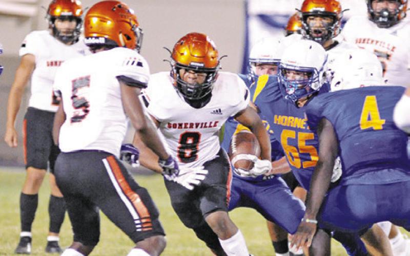 DEVEN GREEN CARRIES the ball for Somerville against Louise. Somerville won 14-13. -- Tribune photo by Denise Squier